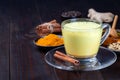 Moon milk with turmeric in a glass cup, ingredients on background, horizontal, copy space Royalty Free Stock Photo