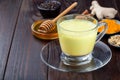 Moon milk with turmeric in glass cup, ingredients on background, horizontal, copy space Royalty Free Stock Photo