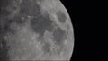 Moon moving large clouds craters in dark night sky.
