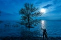 Moon night with asian fisherman work on mangrove forest