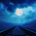 Moon in night clouds over railroad Royalty Free Stock Photo