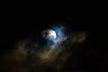 Moon at night covered by clouds carried by the wind. Royalty Free Stock Photo