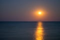 Moon in the night sky, sea horizon, calm, reflection Royalty Free Stock Photo