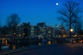 Moon over Amsterdam, Netherlands canals and Royalty Free Stock Photo