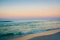 Moon over the Gulf of Mexico at sunrise, in Panama City Beach, Florida