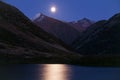 Moon over mountain lakes and lunar path.