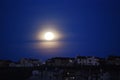 Moon over roof tops Royalty Free Stock Photo