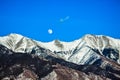 Moon Over Snowcapped Mountain