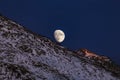 Moon over snowy mountain in Switzerland
