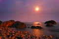 Moon path over the night sea with rocks Royalty Free Stock Photo