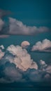 Moon peeks through billowing clouds, creating a mystical ambiance