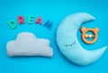 Moon pillow, clouds and dream copy for put newborn in bed on blue background top view