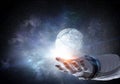 Moon planet in spaceman hand. Mixed media Royalty Free Stock Photo