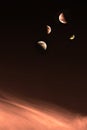 Moon quarters on orangey clouds Royalty Free Stock Photo