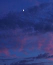 Moon and red clouds on blue sky Royalty Free Stock Photo