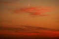 Moon and red clouds after sunset Royalty Free Stock Photo