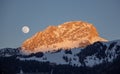 Moon rise and sunset over Italy dolomites with gorgeous light and mountains val di fassa