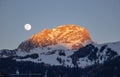 Moon rise and sunset over Italy dolomites with gorgeous light and snowy mountains val di fassa