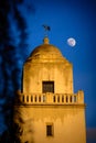 The moon rises above the museum