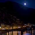 The moon rises from behind the mountain, Monterosso al mare, Cinque Terre, Liguria, Italy Royalty Free Stock Photo