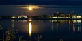 Moon rises over buildings and reflects in Lake Bemidji in Minnesota