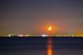Moon rising above sea port Royalty Free Stock Photo