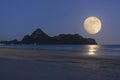 Moon rising over mountain and sea. Royalty Free Stock Photo