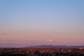 the moon rising over a mountain, view of the valley during sunset Royalty Free Stock Photo