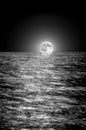 Moon rising over the sea at night. long exposure Royalty Free Stock Photo