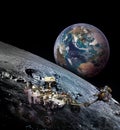 Moon rover on moon surface and planet Earth rising. Royalty Free Stock Photo