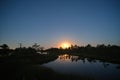 Moon set observingn over lake in Latvia