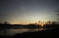 Moon set over forest lake and stars observing after sunset