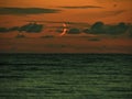 Moon set over sea observing and clouds after sunset Royalty Free Stock Photo