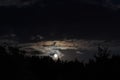 Moon shining at night over a dark forest in Transylvania