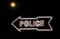 White Neon Sign Points Towards Police Station Dark Night Full Moon