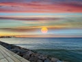 sunset on sea ,full moon  blue clouds  horizon ,emerald green sea wave water  stones  nature landscape tropical island Royalty Free Stock Photo