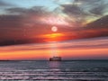 Moon on  starry sky in harbor ,blurred city light at night ,pink sunset at  sea ,ship on horizon seafront people walk  promenade Royalty Free Stock Photo