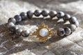 Gemstone bracelet placed on natural grey background