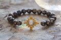 gemstone bracelet placed on natural grey background