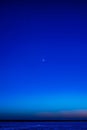 the moon, venus and saturn against a dark blue sky