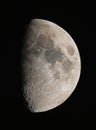 Moon view through a astronomical telescope against the black night sky. Real photo of a space object