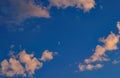 the moon is visible in the blue sky Royalty Free Stock Photo