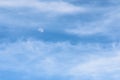 Moon Visible In Daylight Blue Sky With White Clouds