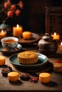 Mooncake on table with tea cups on wooden background and full moon, Mid-Autumn Festival concept