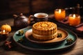 Mooncake on table with tea cups on wooden background and full moon, Mid-Autumn Festival concept