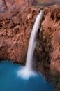 A bird`s eye view of the 200ft Mooney Falls surges in to a beautiful deep blue pool beneath, located on the Havasupai Indian Reser