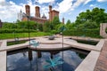 The Moongate Garden with dragonfly statues in the Enid Haupt Garden and the Smithsonian Castle on