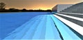 Moonlight falling on the concrete steps visible under clear water of the swimming pool at night. 3d rendering Royalty Free Stock Photo