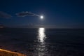 Moonlight path on water of Atlantic ocean at night on Tenerife and dark blue sky with full Moon and stars Royalty Free Stock Photo