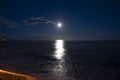 Moonlight path on water of Atlantic ocean at night on Tenerife and dark blue sky with full Moon and stars Royalty Free Stock Photo